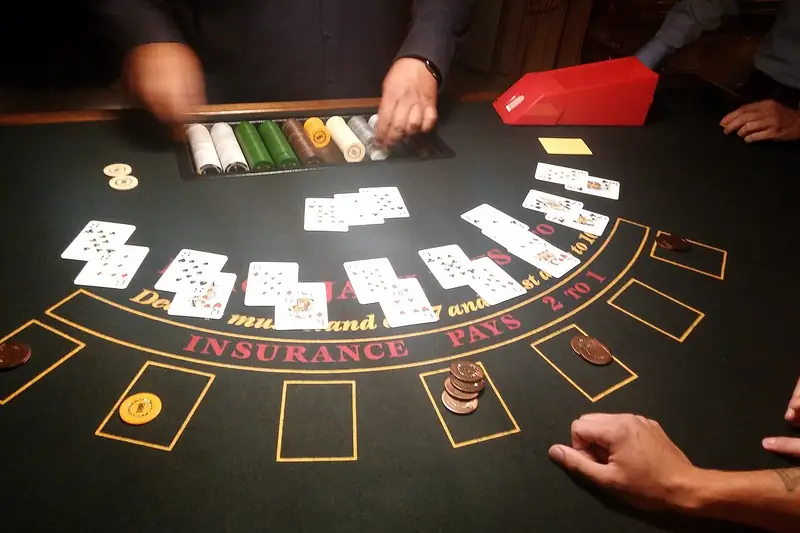 Dealer hands and cards spread across a blackjack table