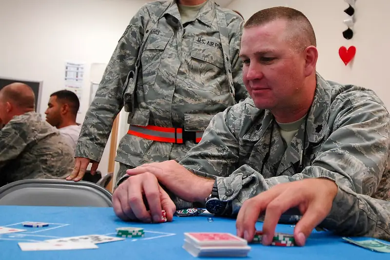 Players sitting at a felt casino card table with chips